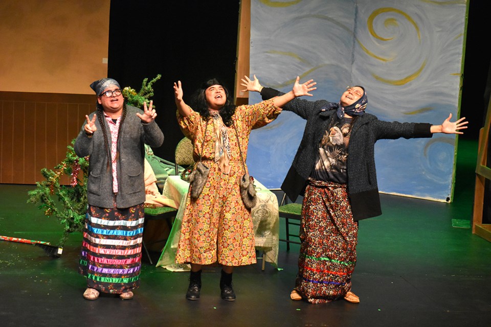 Three Indigenous actors perform on a stage.