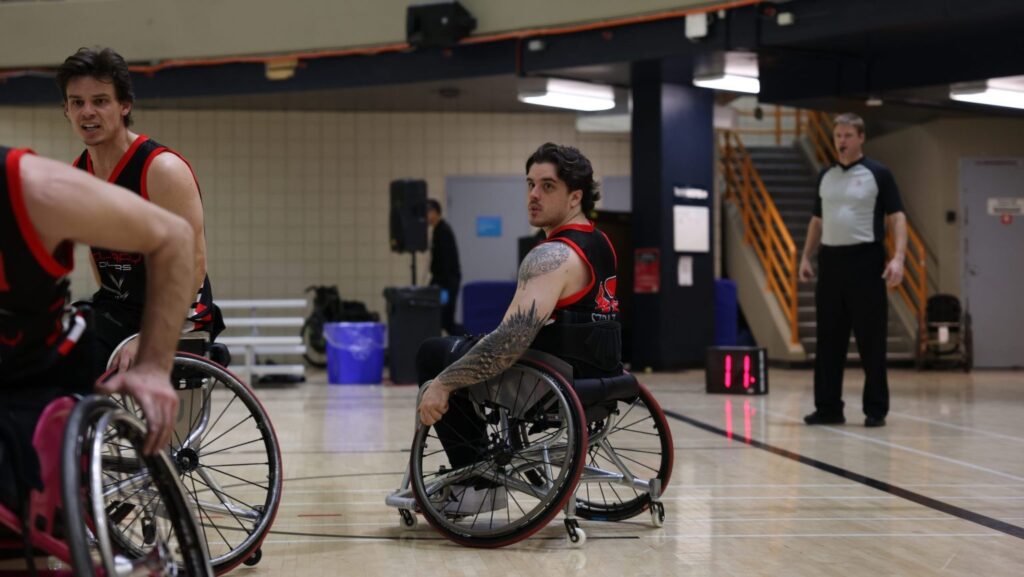 A man in a wheelchair on a basketball court.