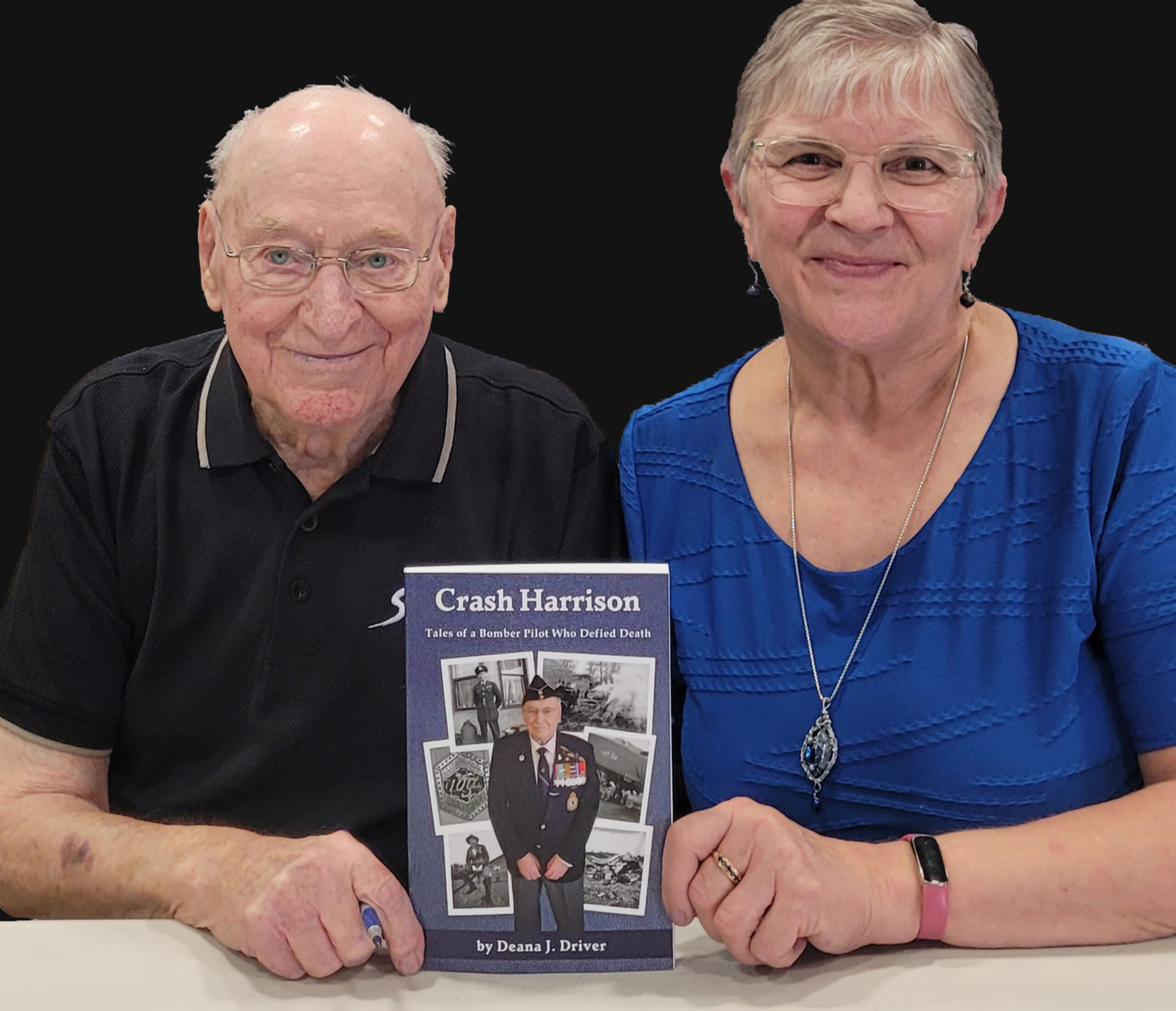 Crash Harrison and Deana Driver holding up their book.