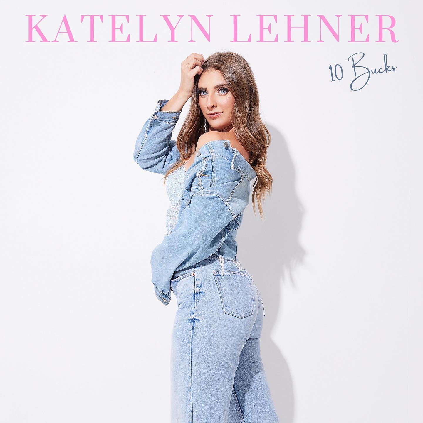 An album cover featuring a plain white background with "Katelyn Lehner" in pink letters, followed by "10 Bucks" in black letters. A woman with long brown hair dressed all in denim looks over her shoulder at the camera.